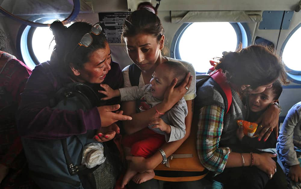 Tourists comfort their crying children inside an Indian air force helicopter after being rescued from a flooded neighborhood in Srinagar.