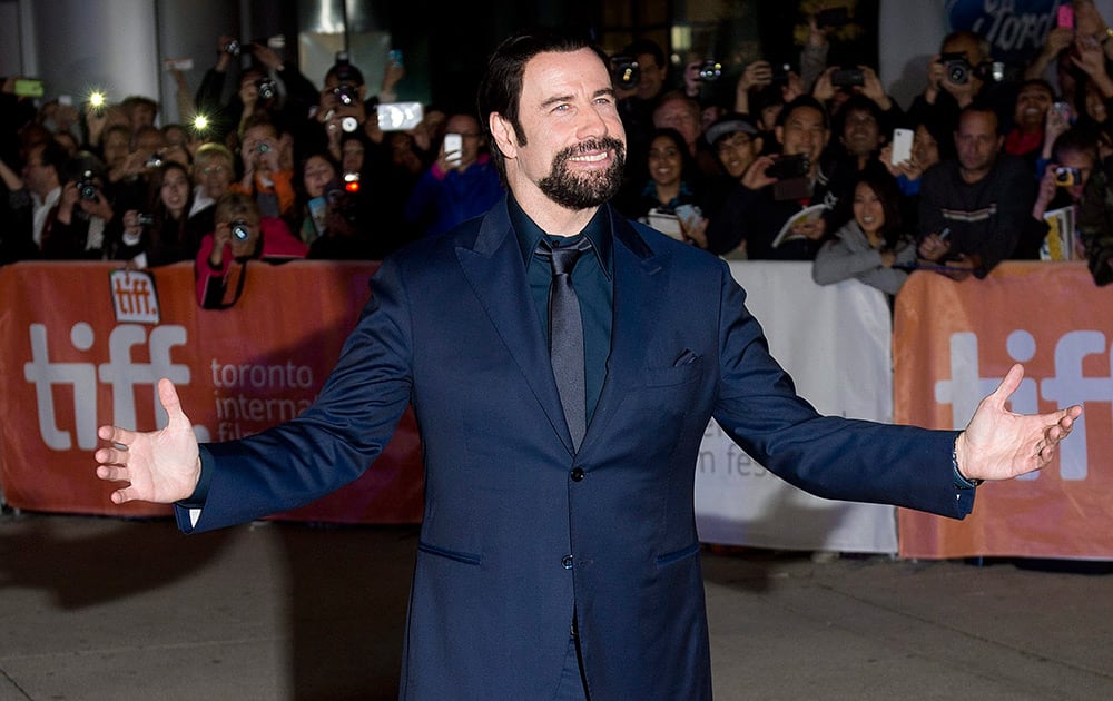 Actor John Travolta poses for photographs on the red carpet for the new movie 'The Forger' during the 2014 Toronto International Film Festival in Toronto.