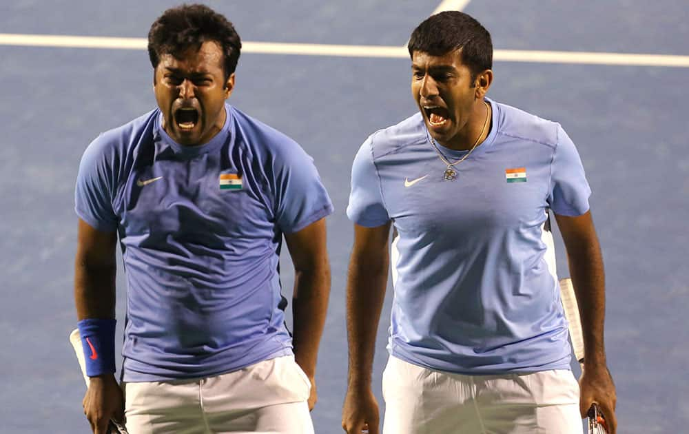 India's Leander Paes, left, and his partner Rohan Bopanna celebrate scoring a point against Serbia's Nenad Zimonjic and Ilija Bozoljac during their Davis Cup tennis World Group play-off tie between India and Serbia, in Bangalore.