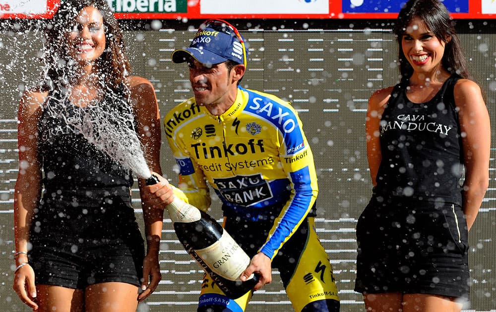 Alberto Contador of Spain celebrates on the podium after winning the 20th stage of the Spanish Vuelta cycling, a 185.7-kilometer (115-mile) ride between Santo Estevo De Ribas De Sil and Puerto De Ancares, Spain.