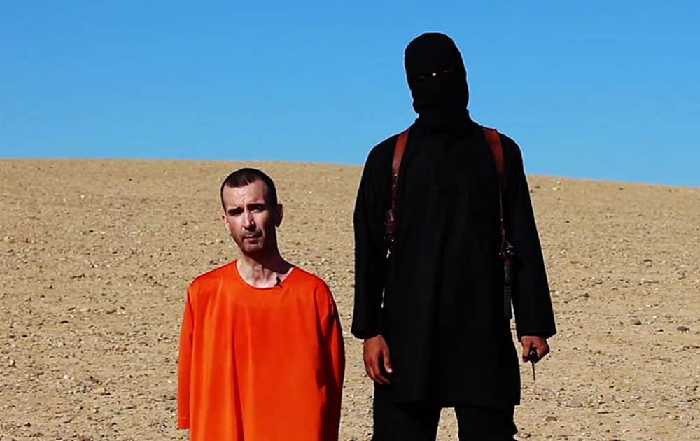 This image made from video posted on the Internet by Islamic State militants and provided by the SITE Intelligence Group, a U.S. terrorism watchdog, on Saturday, Sept. 13, 2014, purports to show British aid worker David Haines before he was beheaded. 