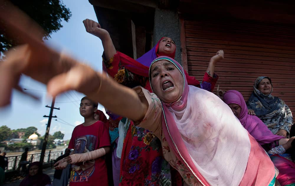 Kashmiri Muslim women wail at Ghulam Qadir's funeral procession after his body was retrieved under the rubble of his house that collapsed in floodwaters in Srinagar, India.