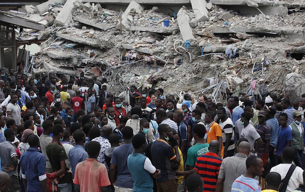 Rescue workers gather at the sits of a collapsed building belonging to the Synagogue Church of All Nations in Lagos, Nigeria.