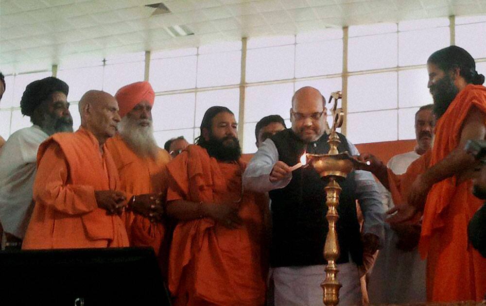 BJP President Amit Shah lighting lamps at a programme at Patanjali Yogpeeth in Haridwar