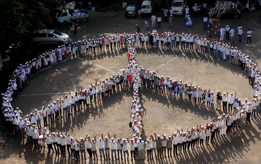 Students formation the peace symbol during the World Peacekeepers Movement celebrated Achievement of one Million Peace Army in Mumbai.