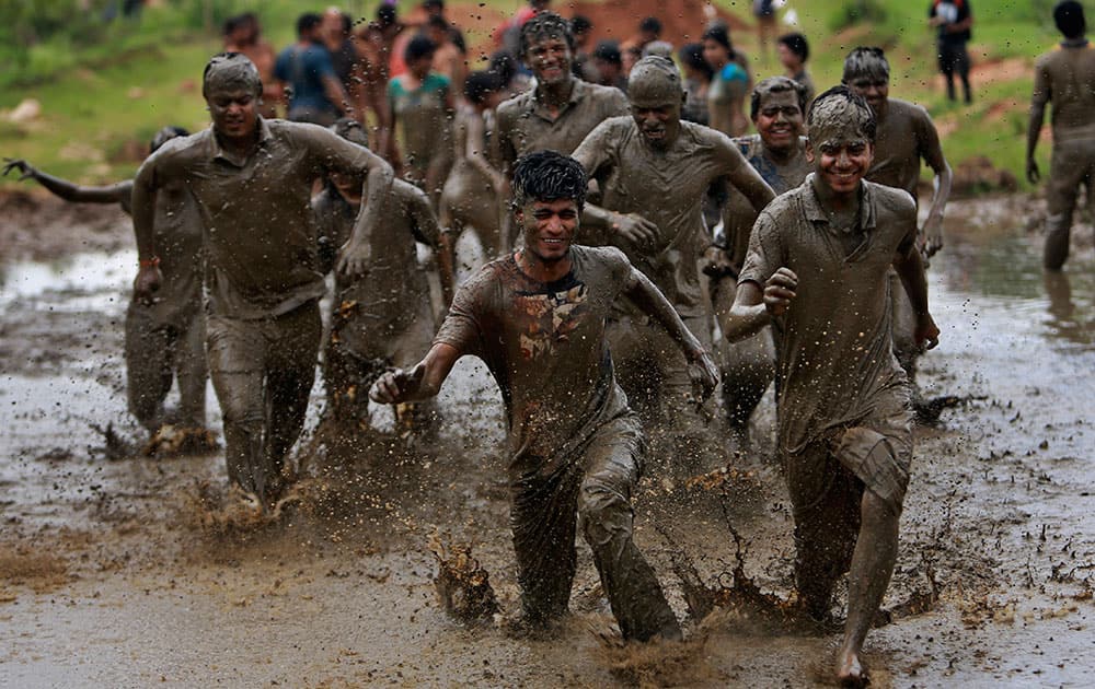 Indian youth participate in a ‘Mud Run’ organized by an organization that promotes adventure sports in Hyderabad, India.
