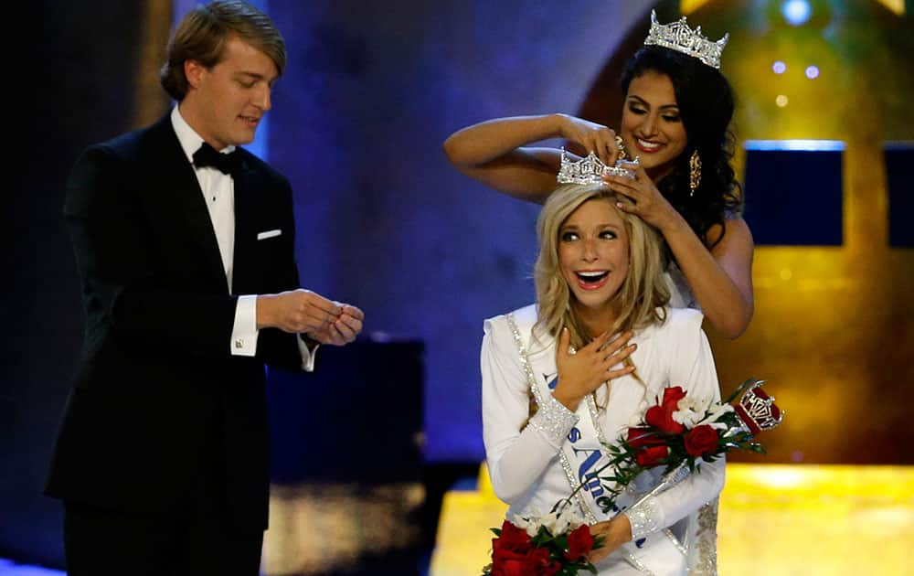 Miss America 2014 Nina Davuluri, top right, crowns Miss New York Kira Kazantsev as Miss America 2015 during the Miss America 2015 pageant, in Atlantic City, N.J.