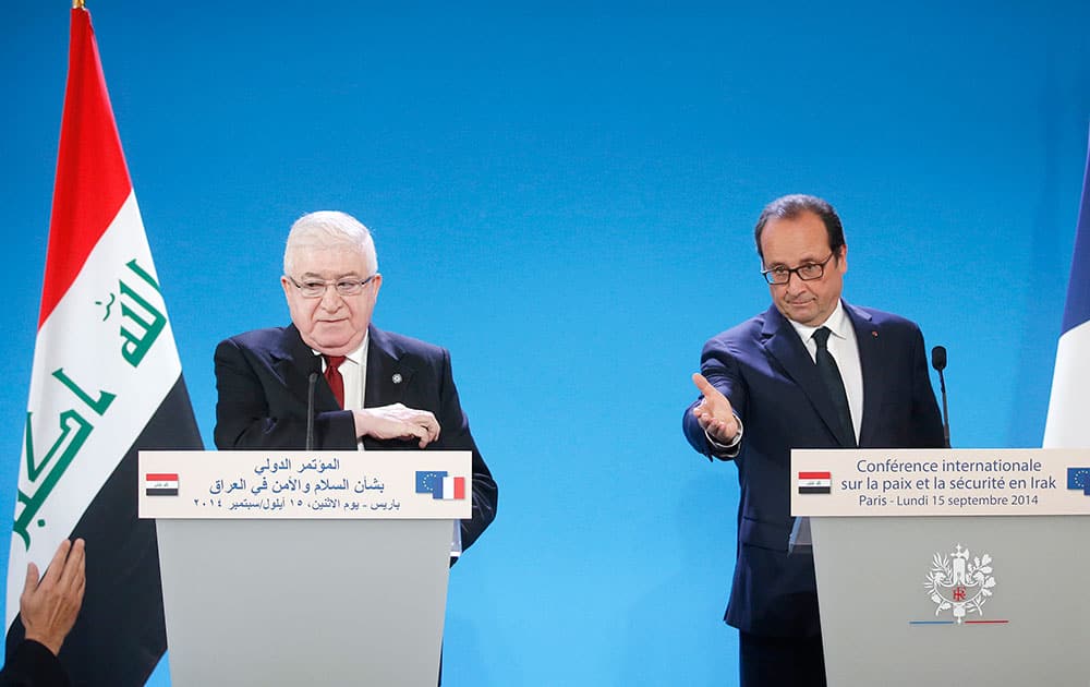 French President Francois Hollande, right, and his Iraqi counterpart Fouad Massoum attend the opening of an international conference intended to come up with an international strategy against the Islamic State group, in Paris.