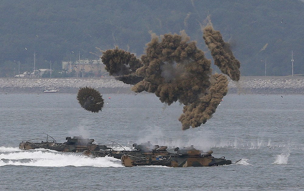 South Korean Marine landing crafts make their way to hit shores through smoke screens during a ceremony to mark the 1950 Incheon landing operations, in waters off Incheon, South Korea. 