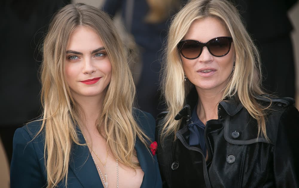 Cara Delevingne and Kate Moss arrive to watch the show by designer Burberry Prorsum for the Spring/Summer 2015 collection during London Fashion Week, at Kensington Gore in west London.