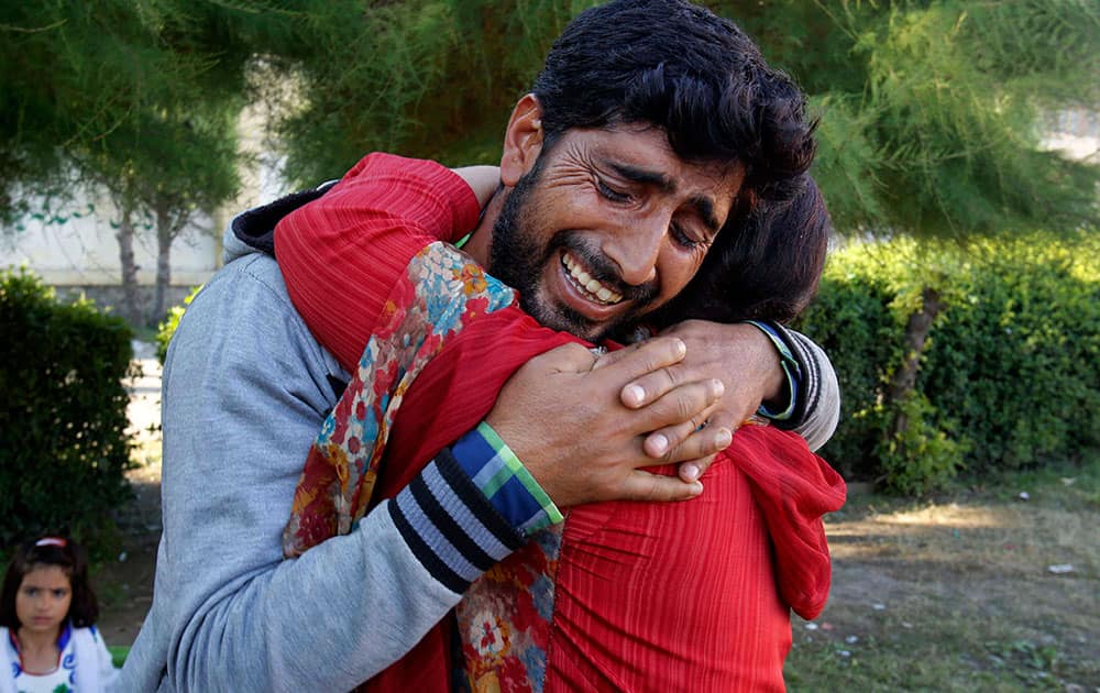 Kashmiri flood victim Nazir Ahamed Dar hugs his sister Rafiqa and cries as they reunite at a relief camp for flood victims in Srinagar.