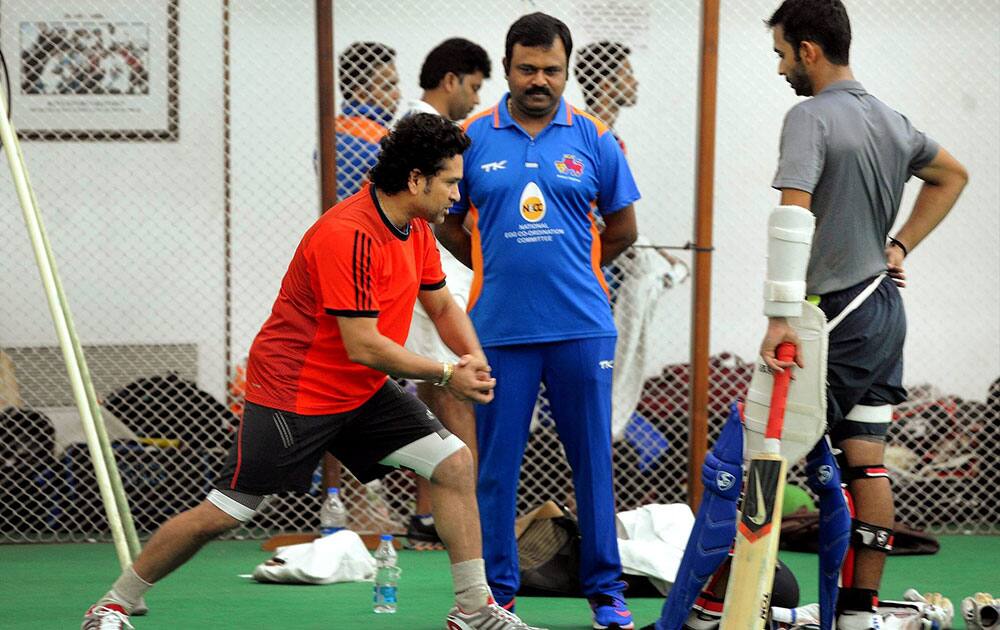 Master Blaster Sachin Tendulkar with Mumbai Coach Pravin Amre and cricketer Ajinkya Rahane during a practice session in Mumbai.
