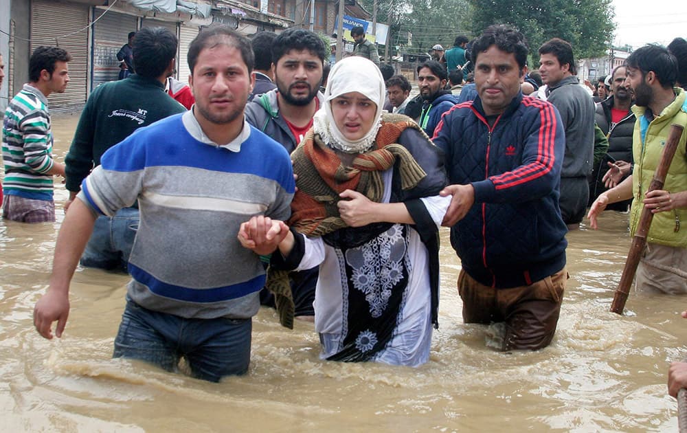 Volunteers rescuing flood affected people in Chattabal in Srinagar.