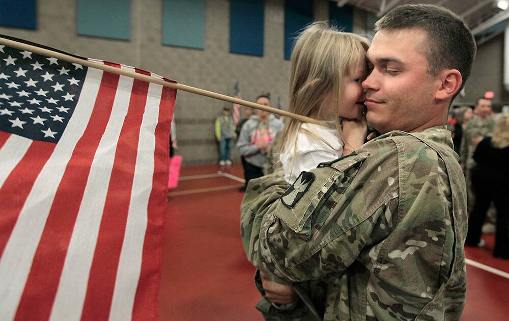 Kinlee Anderson gives her father, Brady Anderson a hug after he returned from Afghanistan at the Inver Grove Heights Training Center in Inver Grove Heights, Minn.