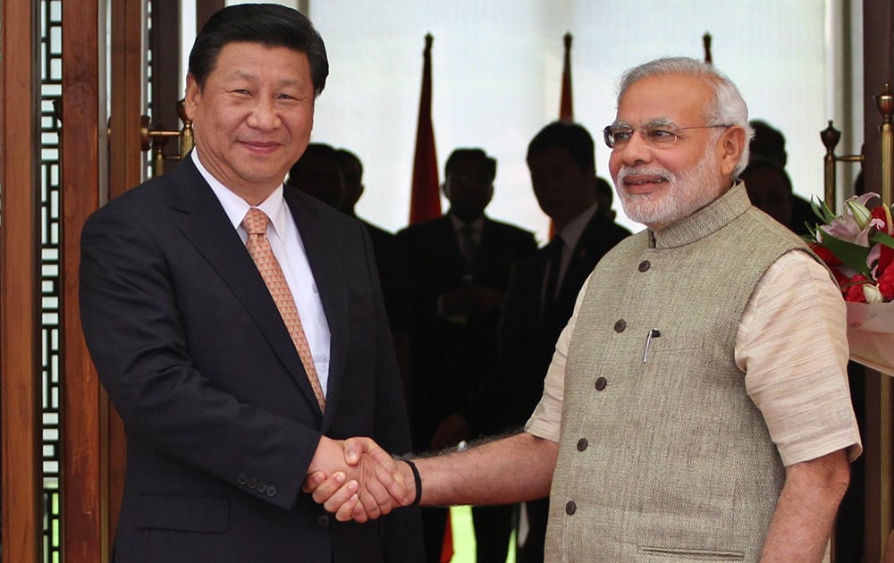 Prime Minister Narendra Modi poses with Chinese President Xi Jinping as he welcomes him upon his arrival at a hotel in Ahmadabad.