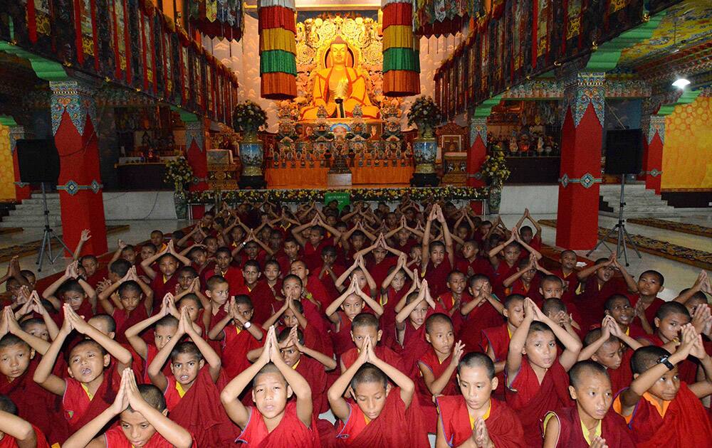 Novice buddhist monks offer prayer at Tergar Monastery for the victims of Jammu and Kashmir floods in Bodh Gaya.