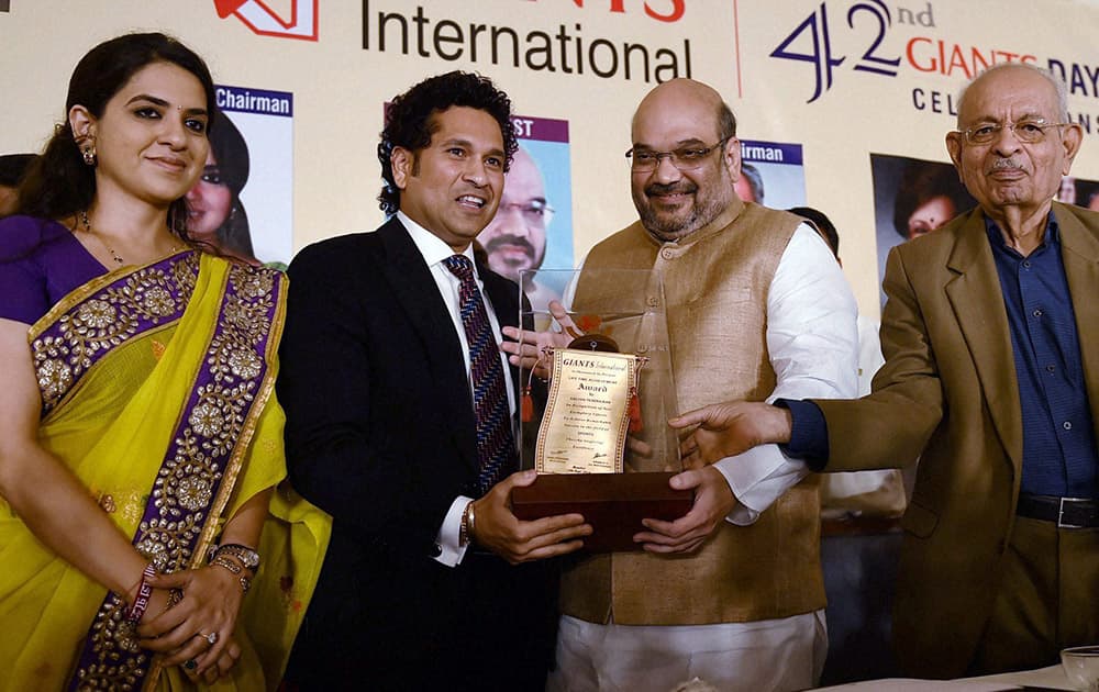 BJP President Amit Shah present Giants award to cricketer Sachin Tendulkar during the 42nd Giants Day Celebrations in Mumbai on Wednesday. Former Mayor Nana Chudasama and Designer Shina N.C in Mumbai are also seen.