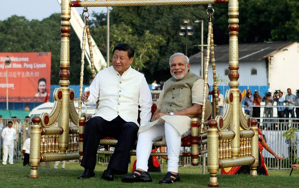 Prime Minister Narendra Modi and Chinese President Xi Jinping sitting on a traditional swing on the Sabarmati River front in Ahmedabad.