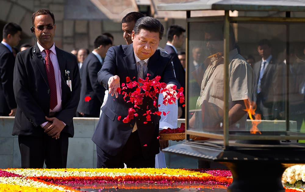 Chinese President Xi Jinping offers floral tribute at Rajghat, the memorial to India's independence leader Mohandas Gandhi, more popularly called Mahatma Gandhi, in New Delhi.