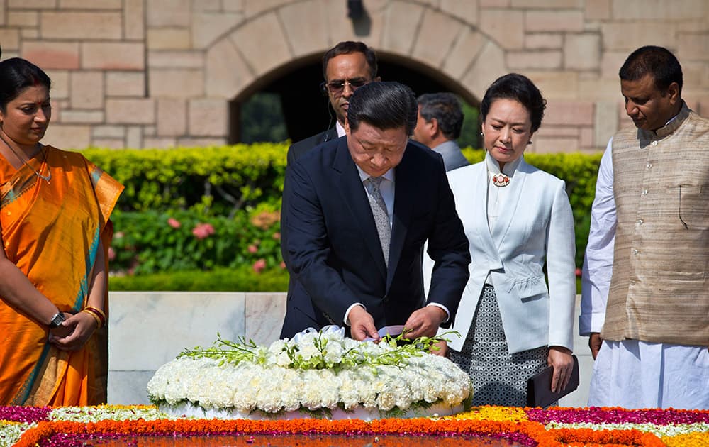 Chinese President Xi Jinping offers floral tribute along with his wife Peng Liyuan at Rajghat, the memorial to India's independence leader Mohandas Gandhi, more popularly called Mahatma Gandhi in New Delhi.