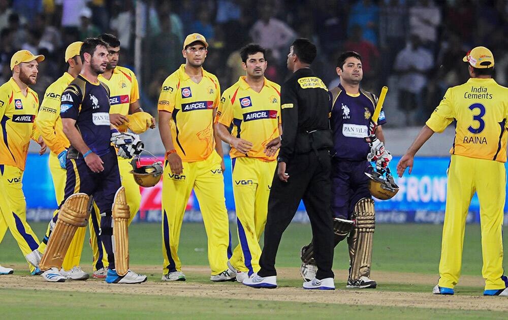 Kolkata Knight Riders walk with Chennai Super Kings after their victory during the Champions League Twenty20 match in Hyderabad.