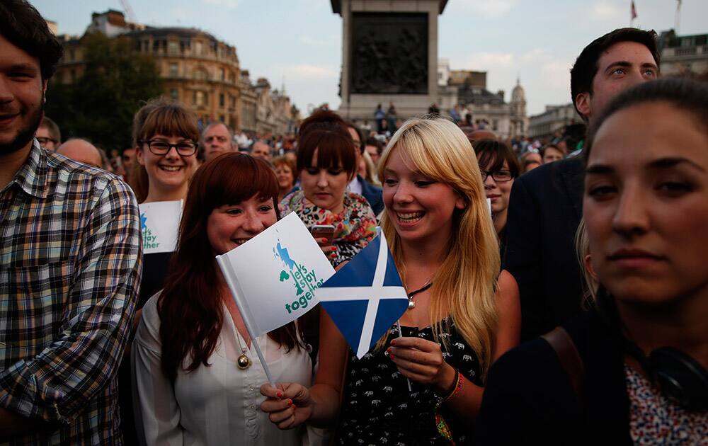 Supporters, one waving a Scottish flag, participate at a pro-union rally at Trafalgar square in central London