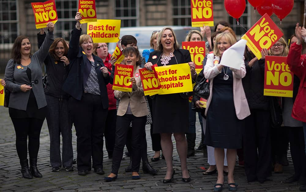 Women campaigning to vote No for the Scottish Independence Referendum cheer as they hold up banners during a rally in Edinburgh, Scotland.