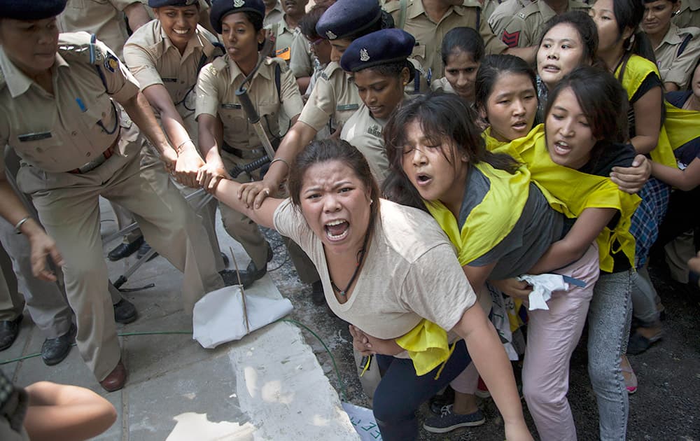 Policewomen detain Tibetan youth activists during a protest to highlight Chinese control over Tibet, outside the Hyderabad House in New Delhi.