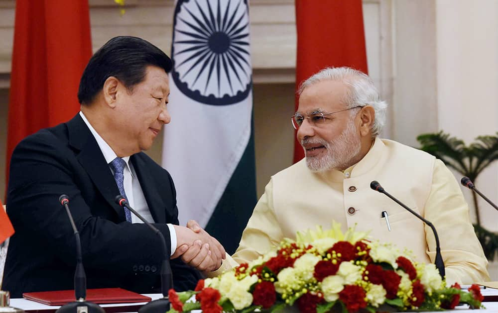 Prime Minister Narendra Modi and Chinese President Xi Jinping shake hands after the joint statement following the agreement signing ceremony at Hyderabad House in New Delhi.