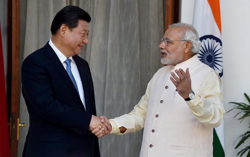 Prime Minister Narendra Modi and Chinese President Xi Jinping shake hands during a meeting at Hyderabad House in New Delhi.