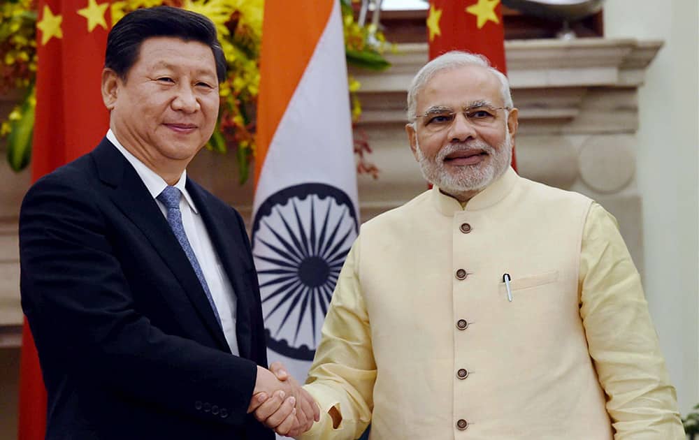 Prime Minister Narendra Modi and Chinese President Xi Jinping shake hands after the joint statement following the agreement signing ceremony at Hyderabad House in New Delhi.
