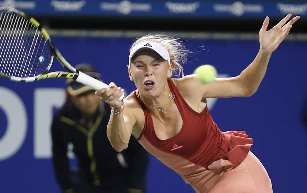 Caroline Wozniacki of Denmark returns a shot against Jarmila Gajdosova of Australia during their second round match of the Pan Pacific Open Tennis tournament in Tokyo.