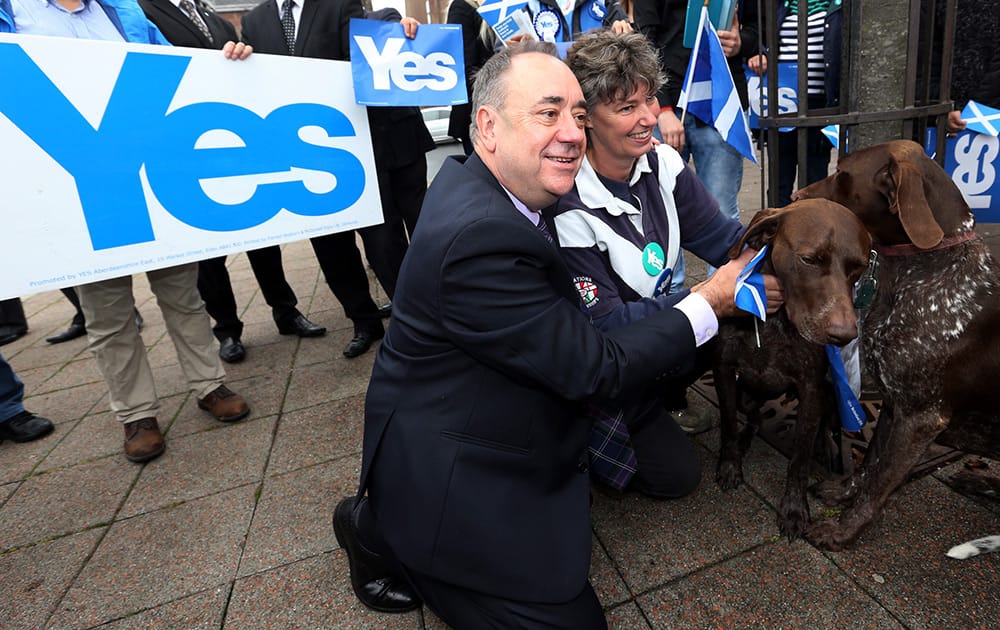 Scotland's First Minister Alex Salmond poses for photographs with Yes campaigners in Turriff, Scotland. Polls opened across Scotland in a referendum that will decide whether the country leaves its 307-year-old union with England and becomes an independent state.