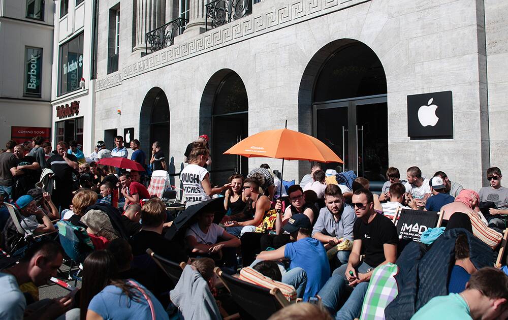 People wait outside the Apple store in central Berlin, Germany. More than hundred people stay outside the shop to buy the new Apple iPhone 6 and 6 Plus devices, scheduled to be released on Friday. 