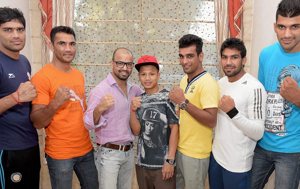 Indian boxing squad, left to right, Satish Kumar, Kuldeep Singh, Akhil Kumar, Devendro Singh, Mandeep Jangra, Manoj Kumar and Amritpreet Singh during a send off ceremony in New Delhi before their departure for Asian Games.