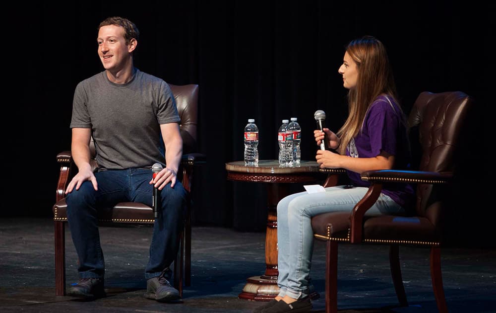 Facebook CEO Mark Zuckerberg,left, answers questions posed by Rosie Valencia during a special assembly at Sequoia High School in Redwood City, Calif.