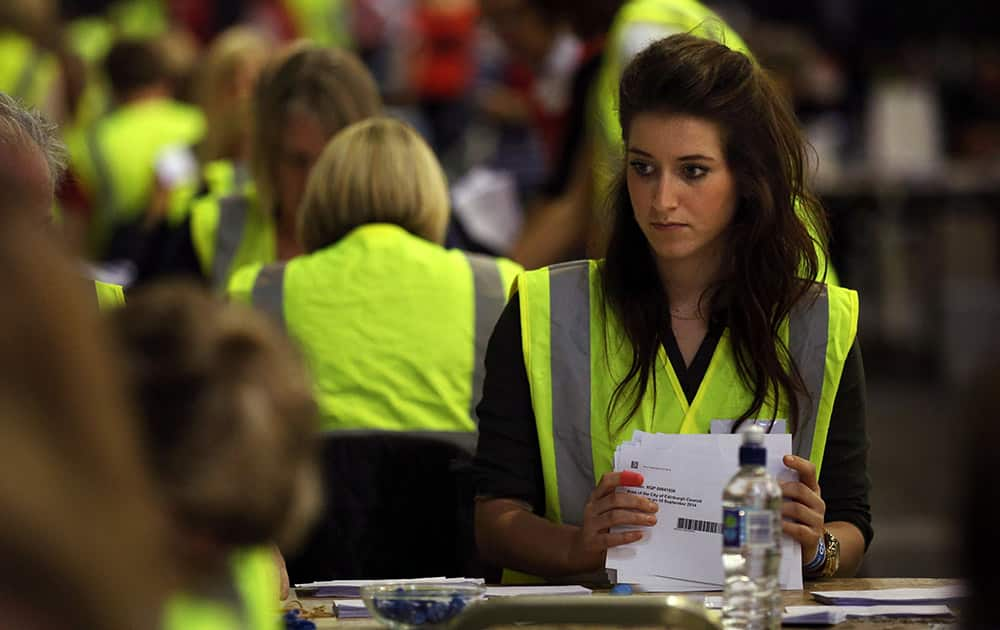 Ballot boxes are opened as counting begins in the Scottish Independence Referendum at the Royal Highland Centre in Edinburgh, Scotland.