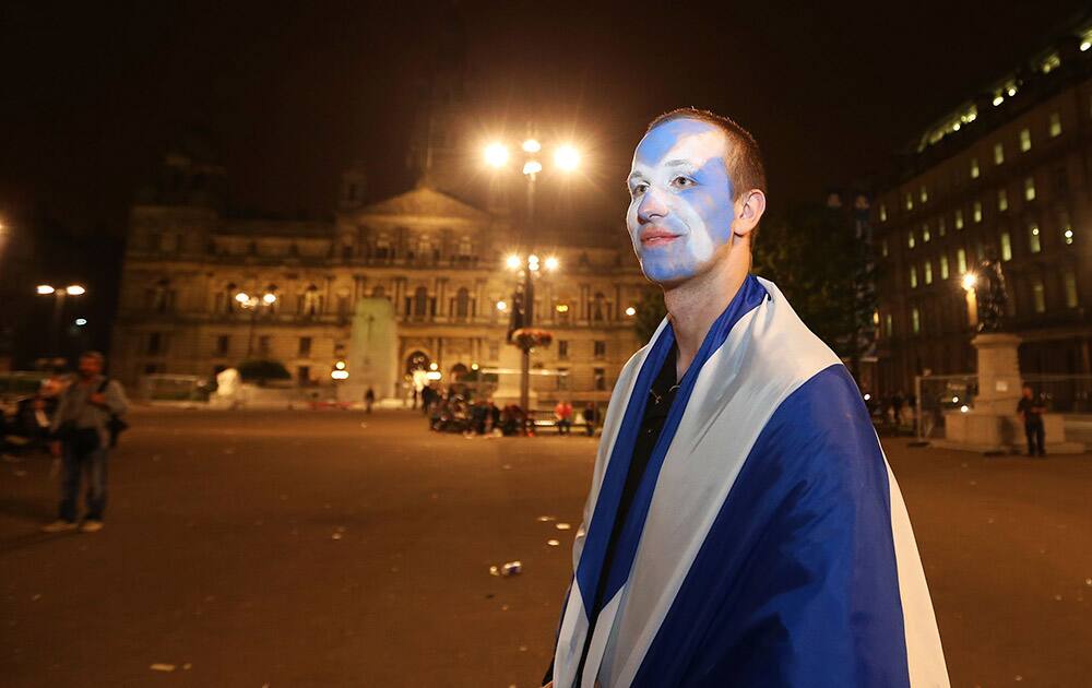 A Yes campaign supporter in the Scottish referendum stands in George Square in Glasgow, Scotland.