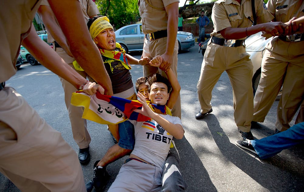 Policemen detain Tibetan youth activists during a protest to highlight Chinese control over Tibet, outside the Taj Palace hotel where Chinese President Xi Jinping is staying, in New Delhi.