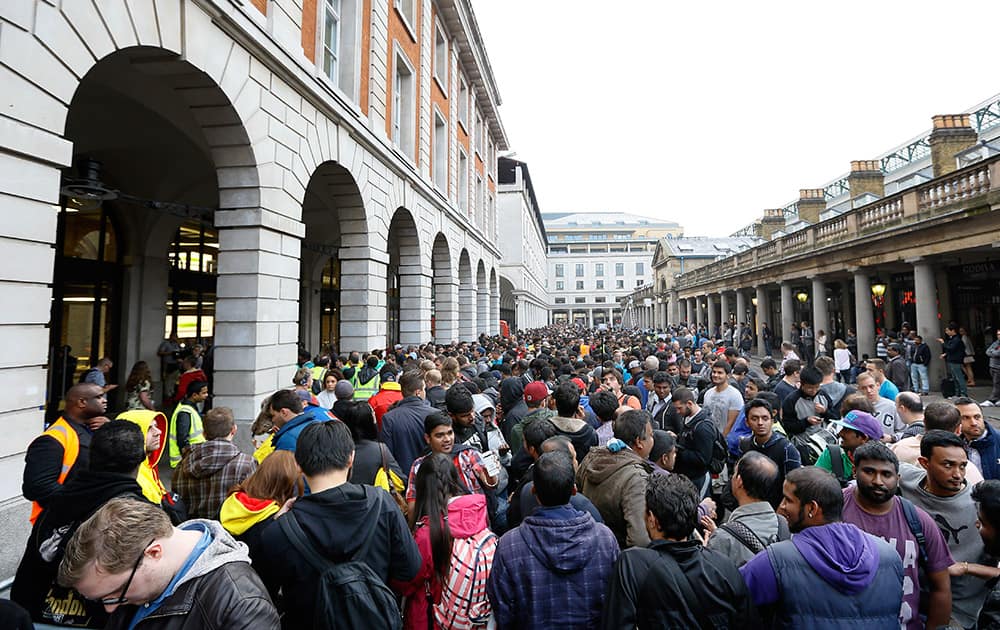 People queue outside an Apple shop in London. The new Apple iPhone 6 went on sale at the shop on Friday.