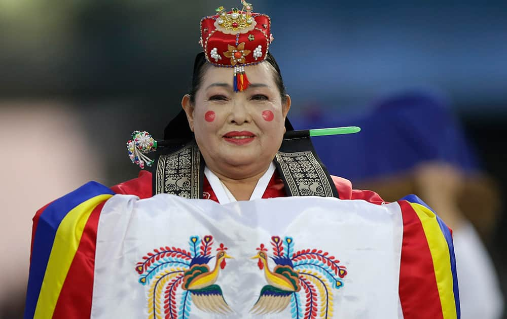 An artist performs during the opening ceremony for the 17th Asian Games in Incheon, South Korea.