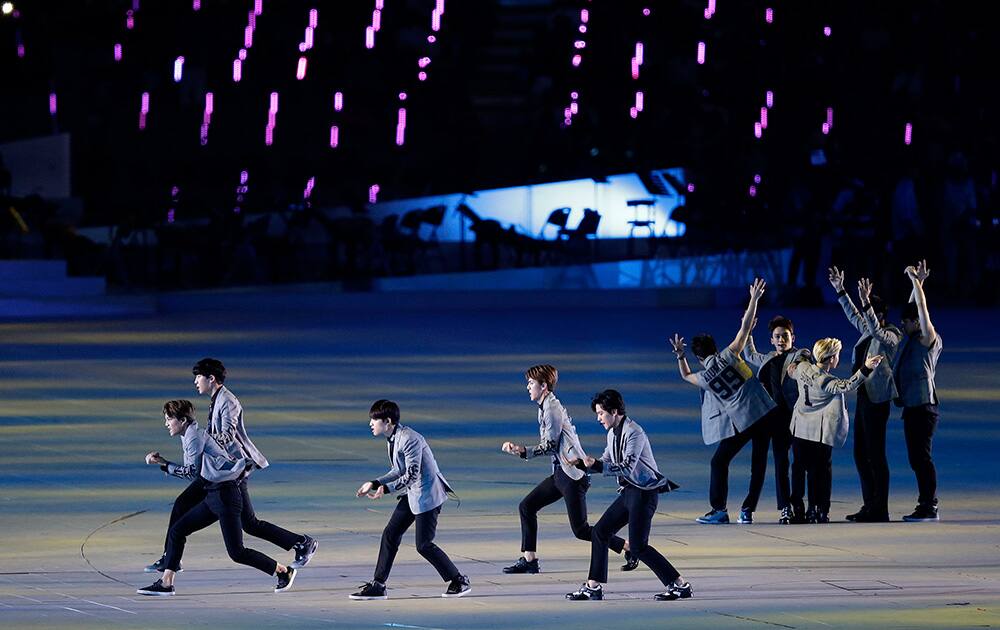 K-pop performers entertain the audience ahead of the opening ceremony for the 17th Asian Games in Incheon, South Korea.