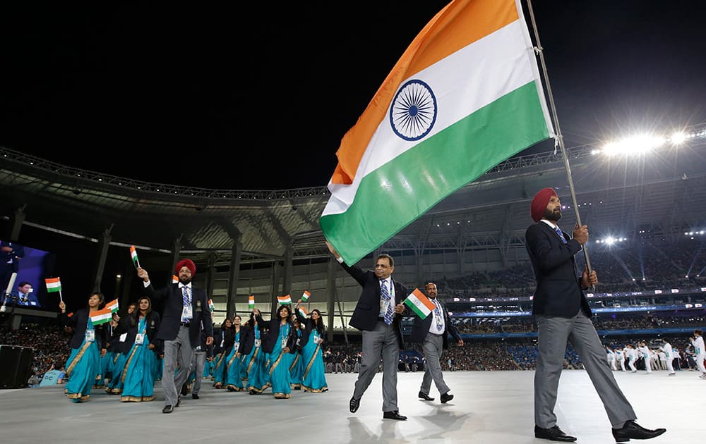 Indian flagbearer Sardar Singh carries his national flag to lead the team into Incheon Asiad Main Stadium during the opening ceremony for the 17th Asian Games in Incheon, South Korea.