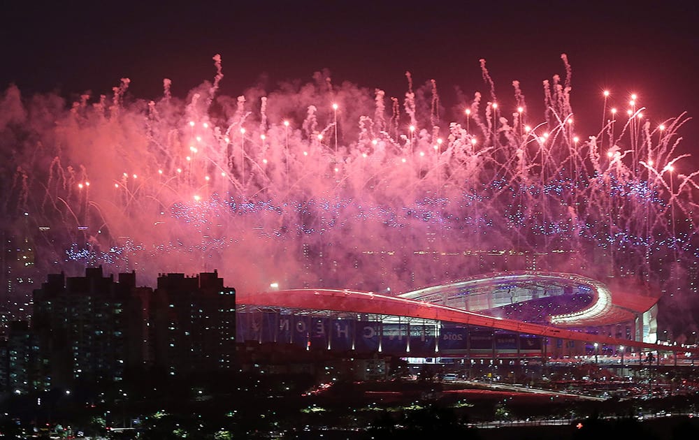 Fireworks explode over Incheon Asiad Main Stadium during the opening ceremony for the 17th Asian Games in Incheon, South Korea.