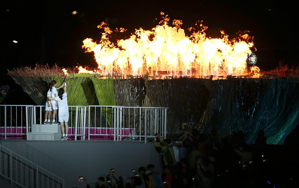 South Korean actress Lee Young-ae lights the tourch at Incheon Asiad Main Stadium during the opening ceremony for the 17th Asian Games in Incheon, South Korea.