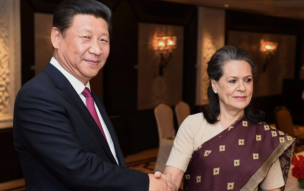 Congress party president Sonia Gandhi and Chinese President Xi Jinping pose for photographers in New Delhi.