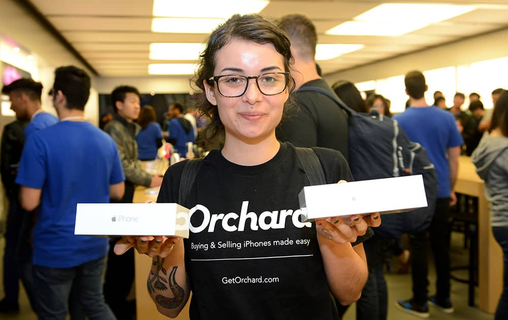 Bianca Torchia shows off two new iPhones at the iPhone 6 launch at the Eaton Centre Apple Store.