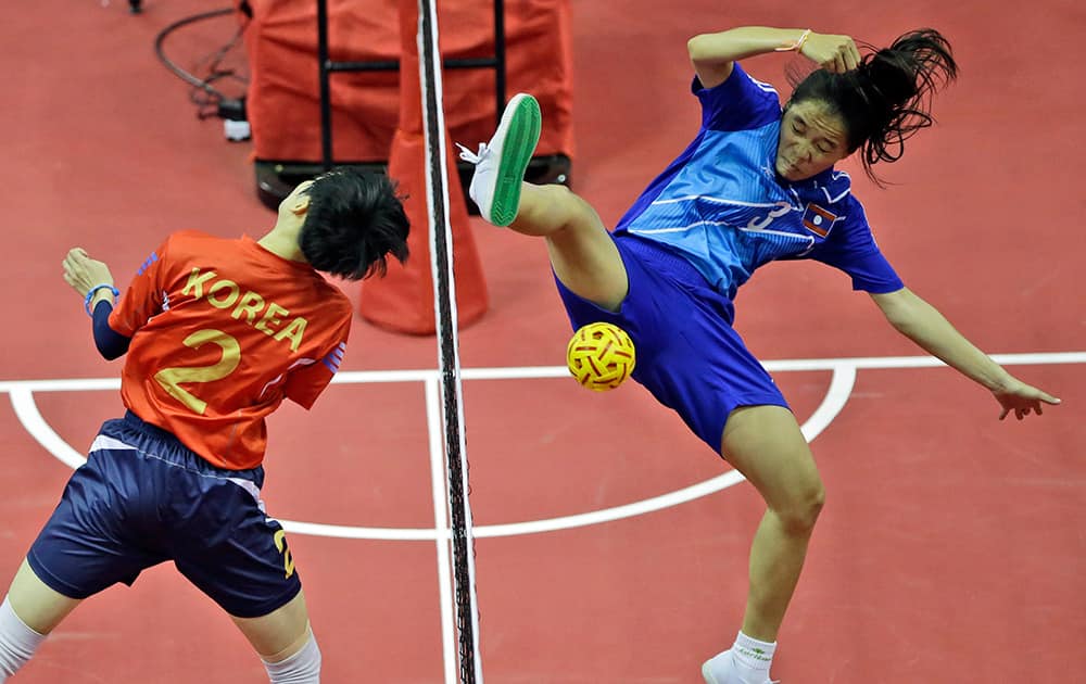 Laos' Koy Xayavong, right, blocks a shot by South Korea's Kim I-seul during their Women's Doubles Preliminary Group A sepak takraw match at the 17th Asian Games in Incheon, South Korea.