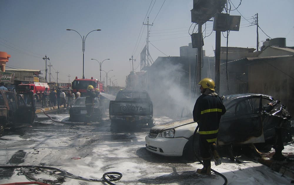 Iraqi firefighters put out fires ignited by a motorcycle bomb attack in Kirkuk, 290 kilometers (180 miles) north of Baghdad,.