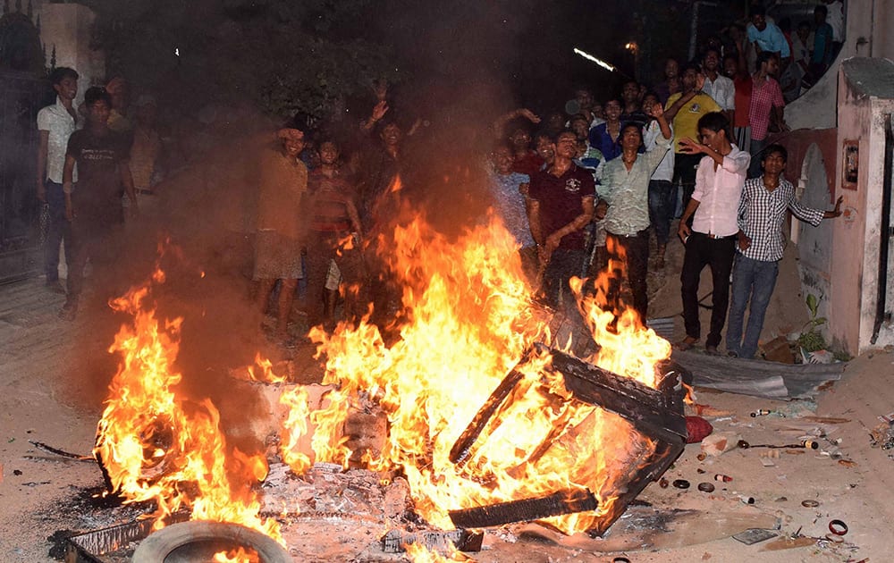 Students set ablaze furniture and other household items after a clash between two groups over room rents, in Allahabad.